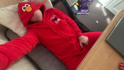 Pawing off in an Elmo onesie.